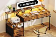 135cm Computer Desk with Power Outlet and Charging Station, Reversible Home Office Desk with Fabric Drawers and Monitor Stand, Wooden Desks with Storage, Study Table, Rustic Brown