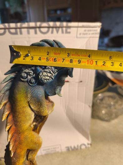 handmade iguana on natural wood log