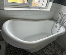 free standing bath with taps and and hose