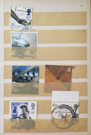 Small brown stamp stock book. 13cm x 18.5cm. 24 page / 12 leaf. Album contains used England Stamps with values over 29p