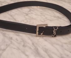 Black leather belt in the style of designer