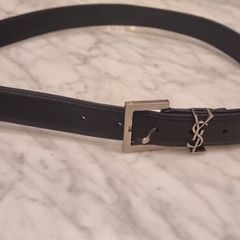 Black leather belt in the style of designer