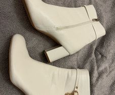 Women's white heeled boots with gold design