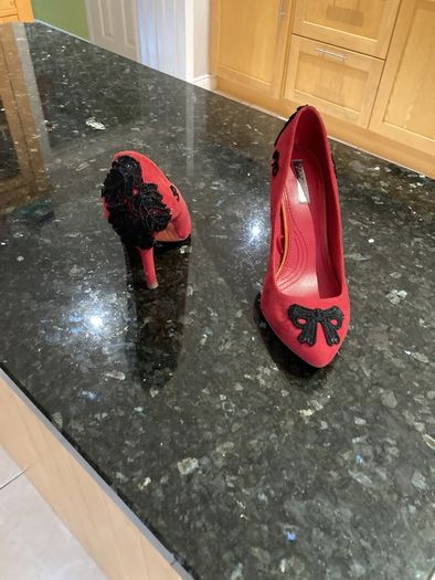 Red high heeled shoes with black lace