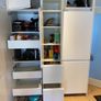 Modern white kitchen units and tall larder storage Image 3