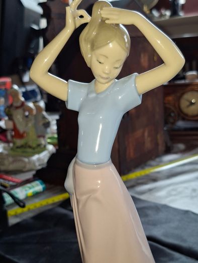 Getting Ready A Young Girl Fixing Her Hair from Nao Porcelain, Lladro, postage available or collection