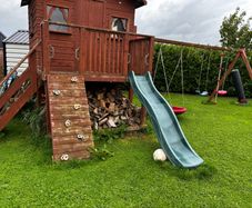 Playhouse with swings and slide
