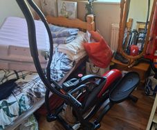 Precor Orbitrek Elite Elliptical Cross Trainer, the black and red moulded body with integral digital console, paired foot platforms