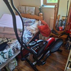 Precor Orbitrek Elite Elliptical Cross Trainer, the black and red moulded body with integral digital console, paired foot platforms
