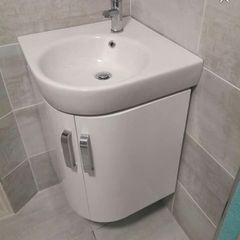 Corner wall hung vanity unit, sink and tap.