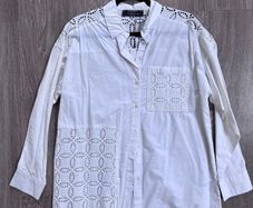 New stylish white button-up blouse, a crisp cotton intricate cutwork (broderie anglaise) panels