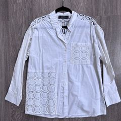 New stylish white button-up blouse, a crisp cotton intricate cutwork (broderie anglaise) panels