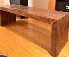 Large, sturdy solid wood coffee table or TV bench in a dark wood finish.
