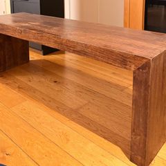 Large, sturdy solid wood coffee table or TV bench in a dark wood finish.