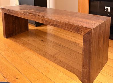 Large, sturdy solid wood coffee table or TV bench in a dark wood finish.