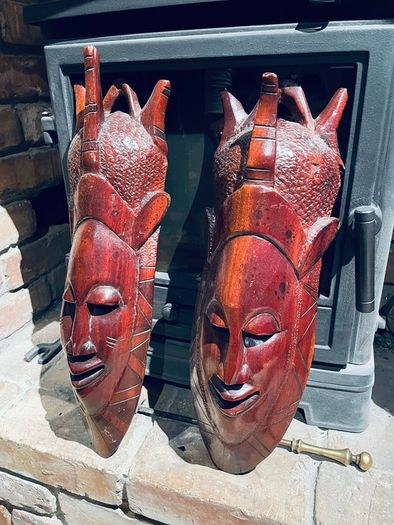 Two carved tribal masks