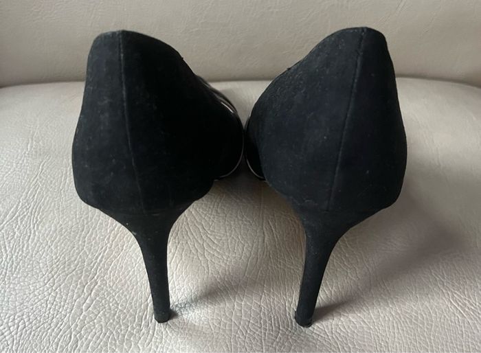 Black high heeled shoe with silver detail front