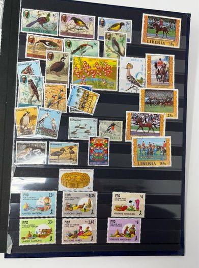 Ace Black 32 page/ 16 leaf Stamp Album with over 900 stamps. Thematic of Animals, Plants, Classic Cars, Space, Trains, Sport & Disney noted.