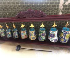 Enamel cloisonne graduated bells on wooden stand
