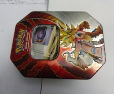 Pokemon Trading Card Game Gouging Fire tin box with bulk cards
