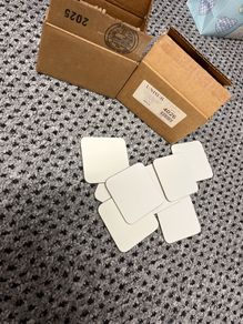 Coasters, plain white, new in box, about sixty five