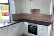Kitchen including integrated dishwasher and cooker