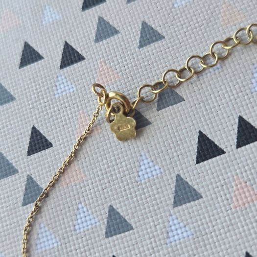 925 sterling silver bracelet with yellow gold plating and V shaped pendant.