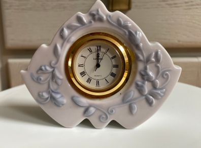 Rare Vintage Lladro Marbella Quartz Desk Clock (5652)  crafted from glazed white porcelain with delicate blue floral details and a gold rimmed face.