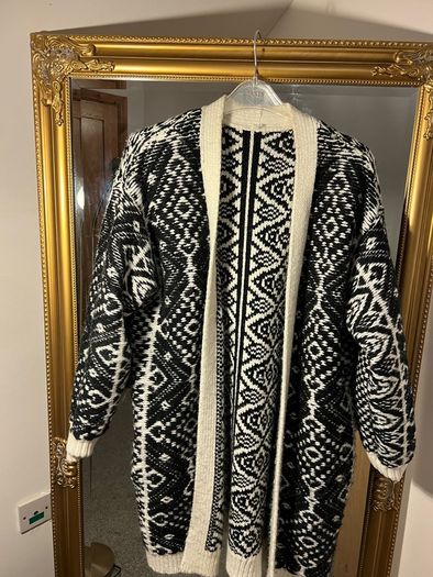 Reversible knitted piece cardigan, a structured jacket, or a coat. Very warm.