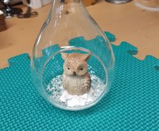 Owl ornament in glass container