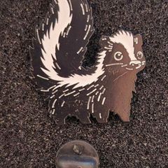 Skunk ,  pin back badge.