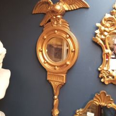 Antique gilt wall mirror  eagle pediment.