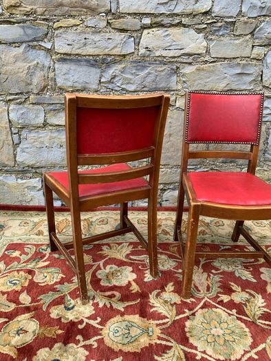 A pair of mid century leatherette kitchen chairs.