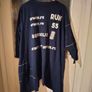 long-sleeved navy garment is an oversized graphic Jacket cardigan. Image 2