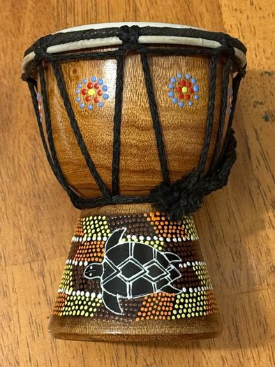This is a small hand-carved Australian drum with a hand-painted turtle design