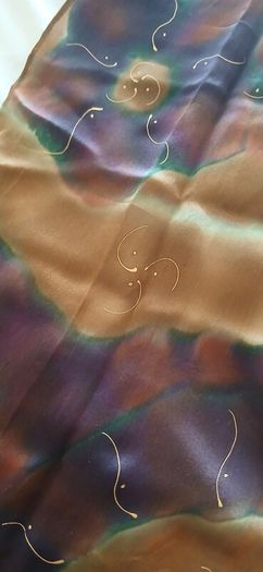 Hand painted, 100% silk scarf featuring a hand-rolled hem and custom metallic gutta detailing.