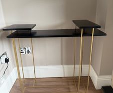 Brass and black console table