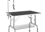 Folding pet grooming and trimming table with adjustable height and mesh basket