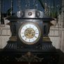 Victorian French Black Slate Mantle Clock (Very large and heavy) with bronze ornamentation Oversized. Open escarpment slate plate Roman numerals. Circa 1890s. Accented with Trojan head. Flanked by two Hellenistic ladies heads on sides. Rose cartouche mask Image 2