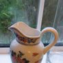 Faux Flowers in Pretty Jug. Image 4