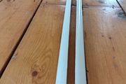 Two 2.4m lengths of white wooden moulding 10x10mm