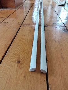 Two 2.4m lengths of white wooden moulding 10x10mm