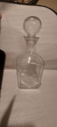 Art deco glass whiskey decanter with lid,,buyer collects or pays postage thank you, good patina condition,,sold as is, see pictures for condition,,