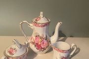 Vintage Porcelain small teapot sugar bowl and creamer set .       porcelain