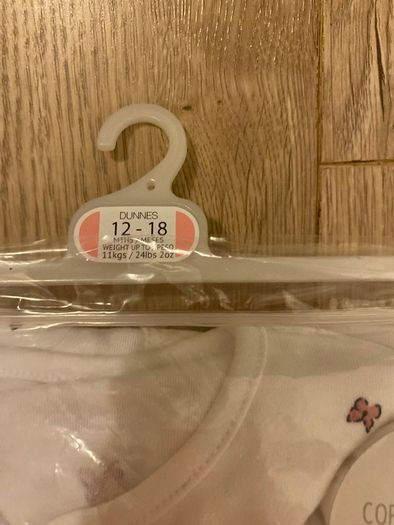 Baby cotton sleepsuits and soothers
