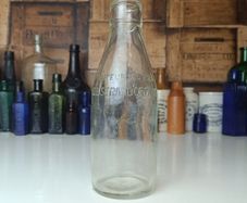 502 - Vintage Clear Glass Cork Top Collectible Decorative Lee Strand Creamery Milk Bottle