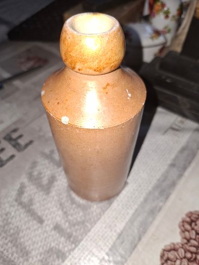 Antique stoneware ginger beer bottle from the Norfolk brewer Steward & Patteson Limited, featuring a "1D" (one penny) price mark