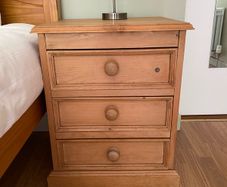 Solid antique pine three-drawer bedside locker