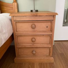 Solid antique pine three-drawer bedside locker