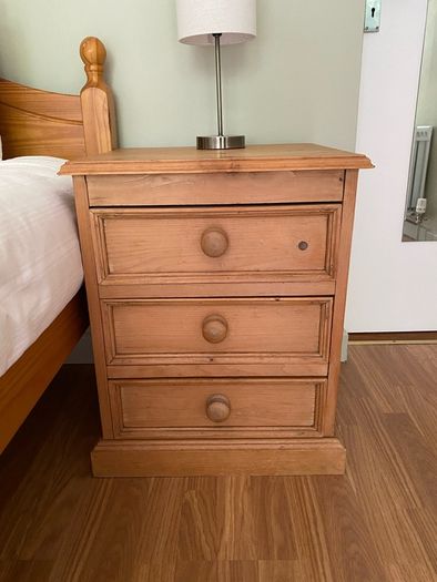 Solid antique pine three-drawer bedside locker
